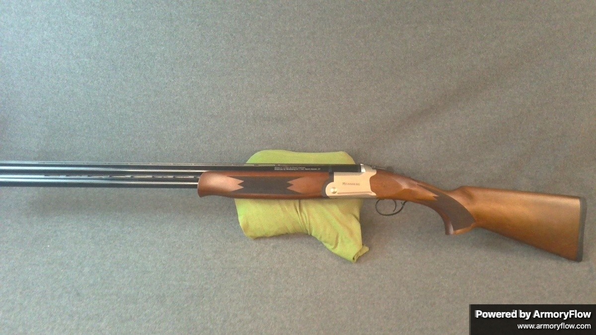 Mossberg Silver Reserve 12 gauge shotgun with interchangeable extended chokes. This over-and-under design is ideal for hunting and sport shooting applications.